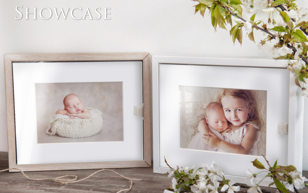 two showcase boxes sitting on a wooden ledge with mounted family images